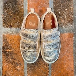 Tom’s gold Velcro sneakers